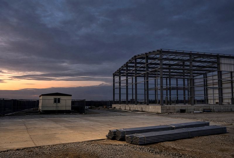 Editorial photograph of an empty completed industrial jobsite at dusk. Not Echelon client work.